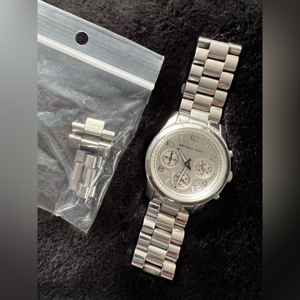 Women’s Michael Kors watch. With extra links to add back in for size. No box.